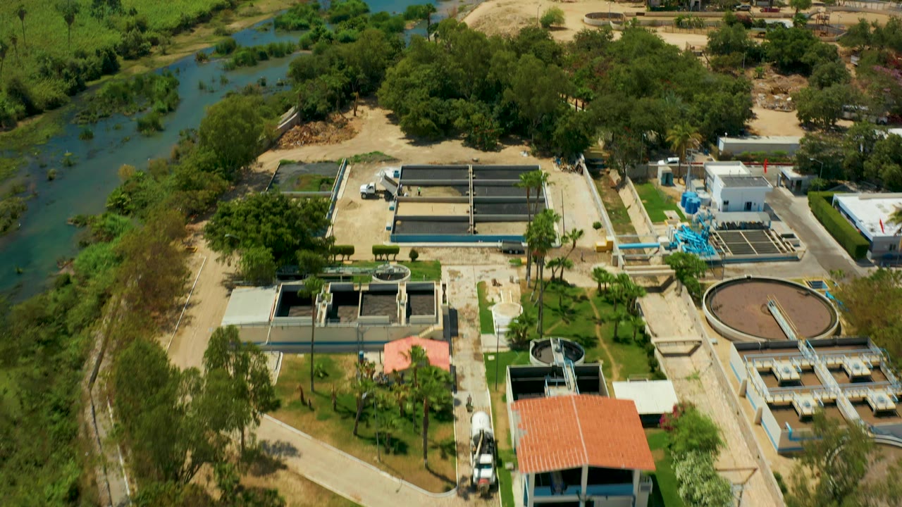 Aerial angle over basins, road, roof, and river