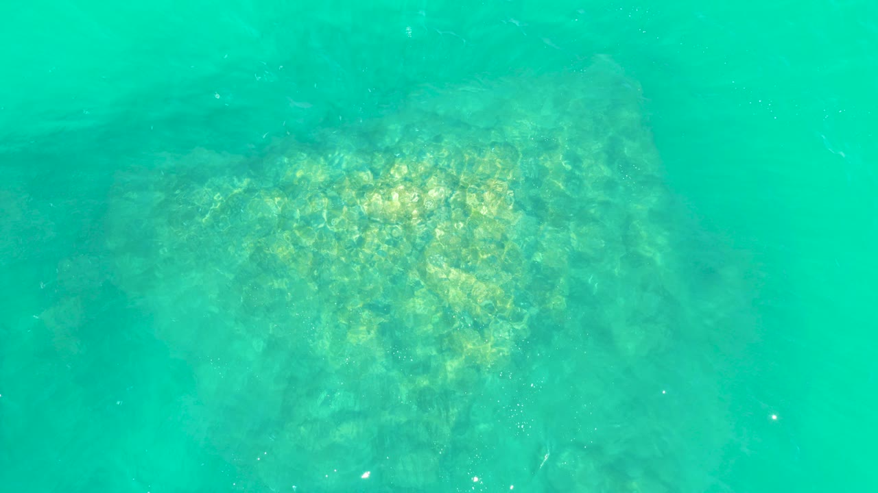Turquoise underwater view of a rocky seabed
