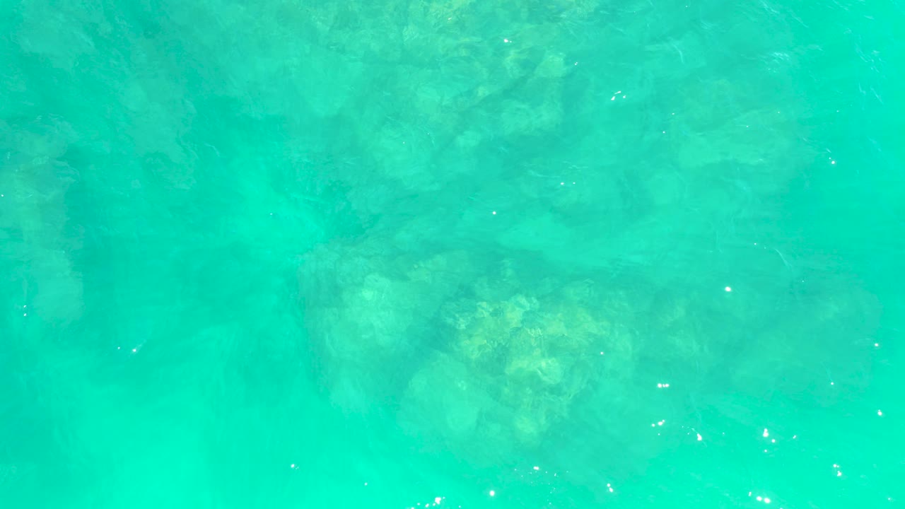 Turquoise water over a rocky seabed