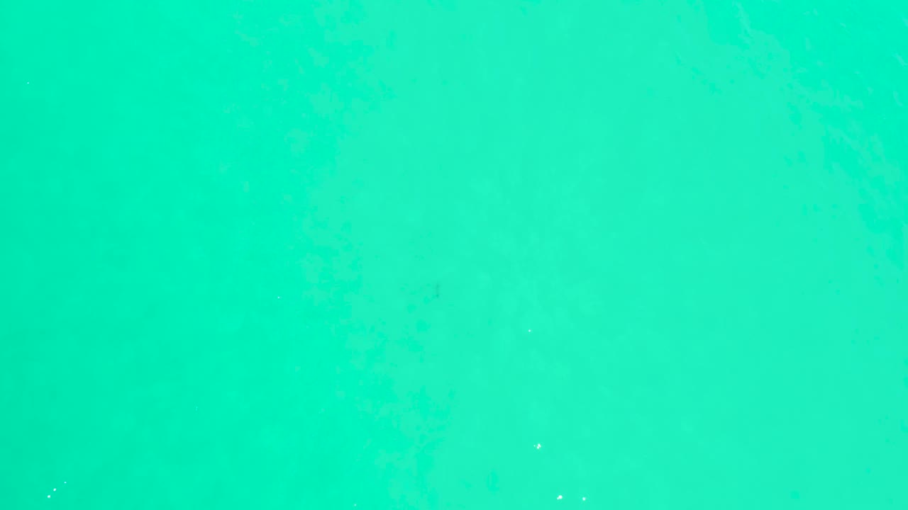 Bright aqua water fills the fourth frame from the Marquis Los Cabos clip, showing only subtle texture and no visible people.