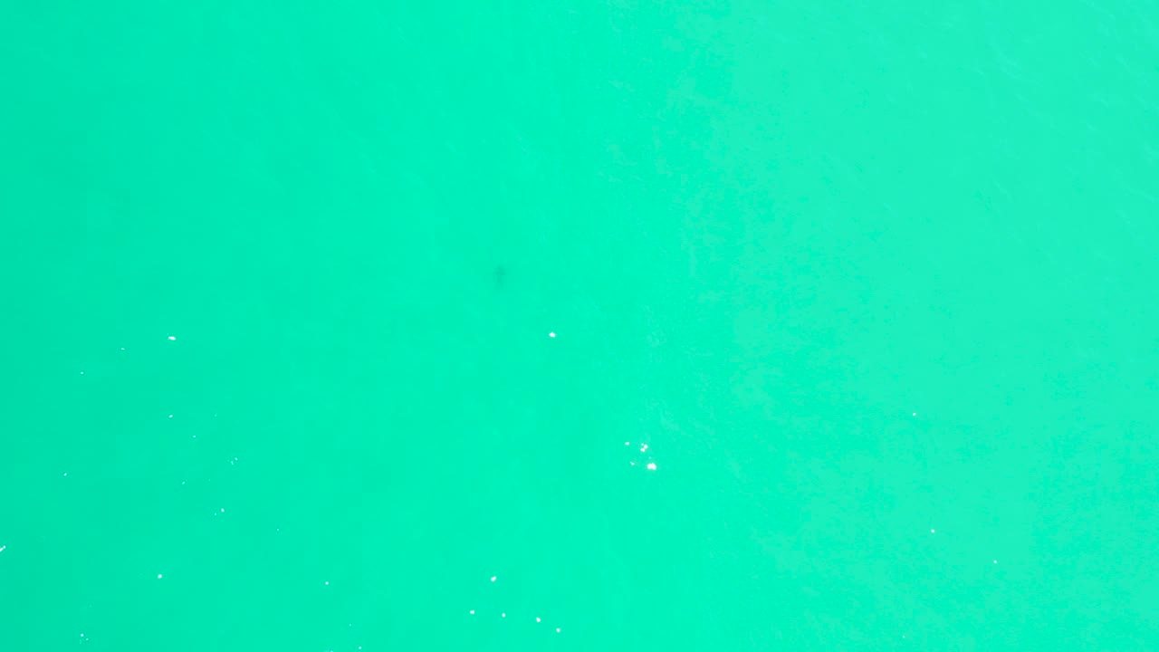 Overhead turquoise ocean surface at Marquis Los Cabos, Baja California Sur, with faint ripples and no visible people.