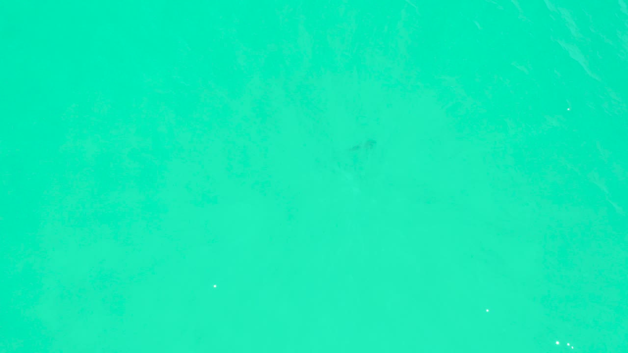 Turquoise sea surface at Marquis Los Cabos with faint diagonal wave lines and no visible people.