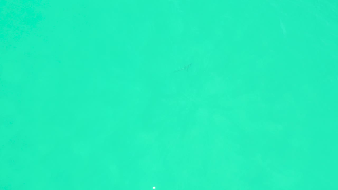 Turquoise water at Marquis Los Cabos, Mexico, with subtle ripples, soft underwater color changes, and no visible people.