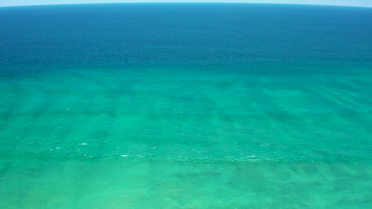 Turquoise ocean water with a darker blue horizon band