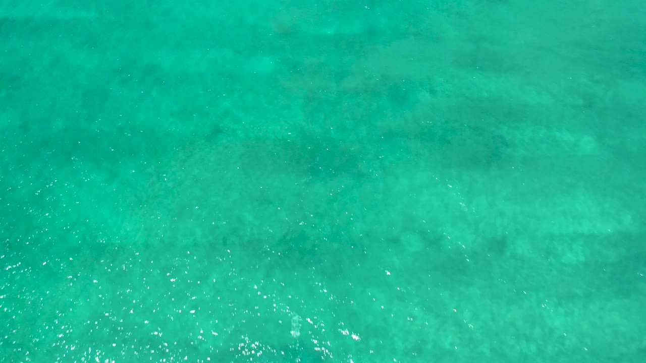 Turquoise shallow ocean water with small sunlit ripples.