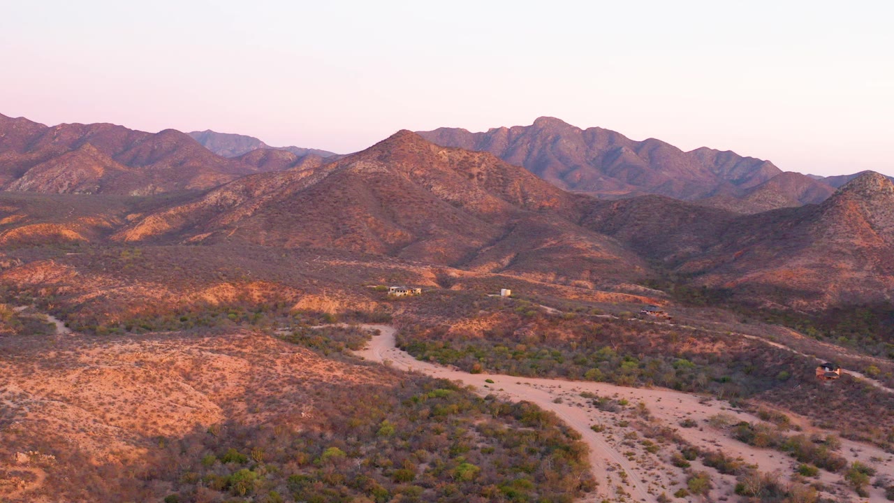Wide desert road and mountains at dusk