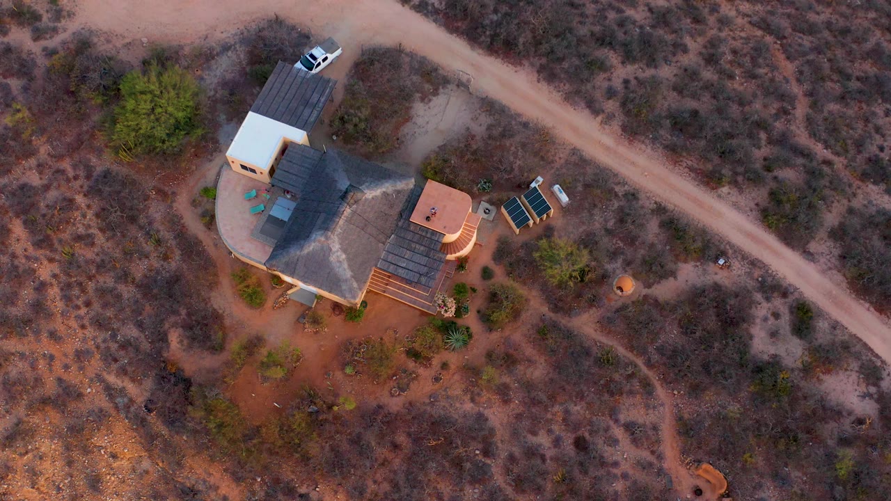 Closer overhead composition of a house compound in dry desert terrain.