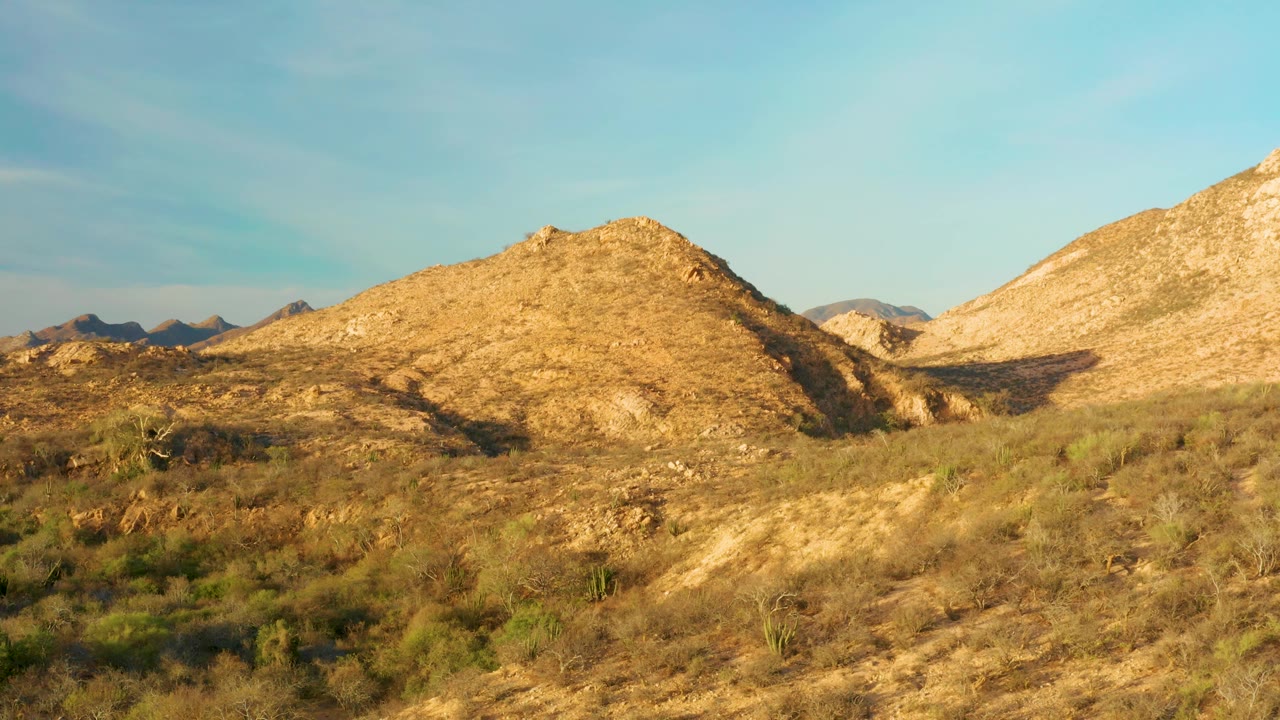 Desert hillside with rocky ridge and open sky