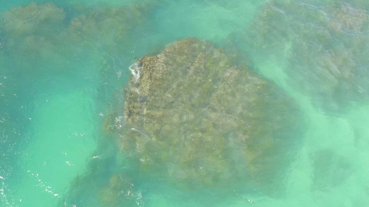Clear water rippling over submerged rocks