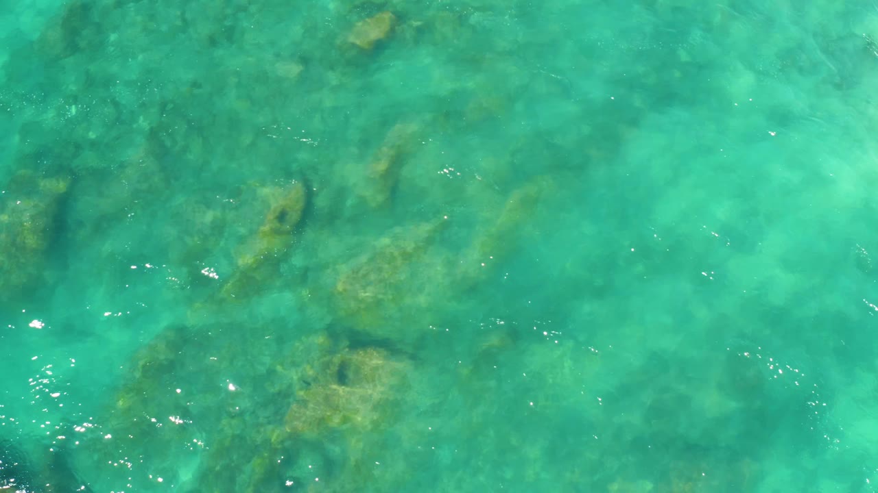 Submerged rocks in turquoise ocean