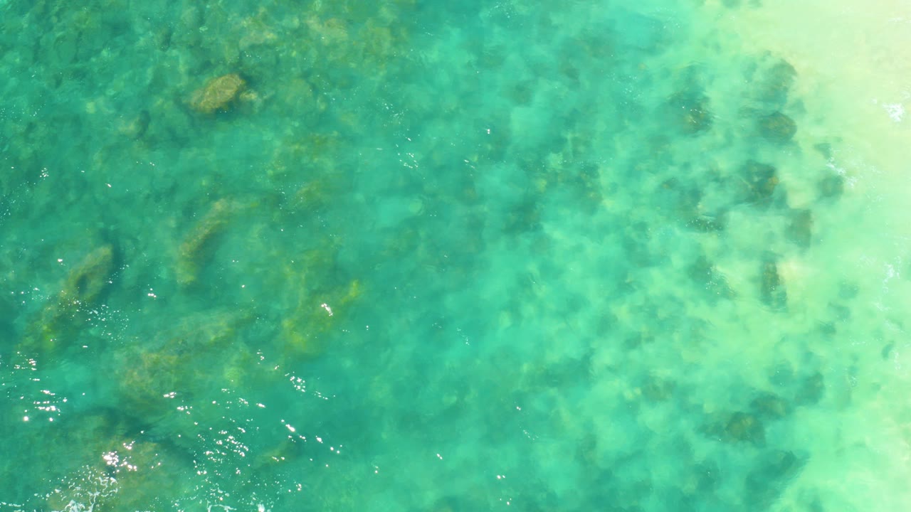 Clear turquoise water over a rocky seabed.