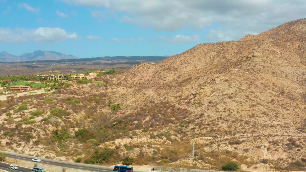 Second frame shows the Hilton Los Cabos, Mexico hillside filling the right side, with moving cars on the foreground highway, low buildings to the left, and no visible people.