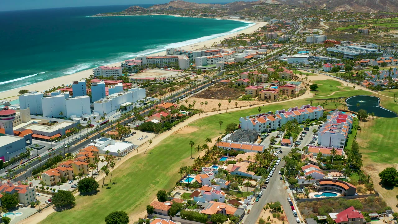 Third frame shows the San Jose Del Cabo shoreline stretching across the upper image, with turquoise water, pale sand, resort-scale buildings, a central road, lawns, homes, hills, and no visible people.