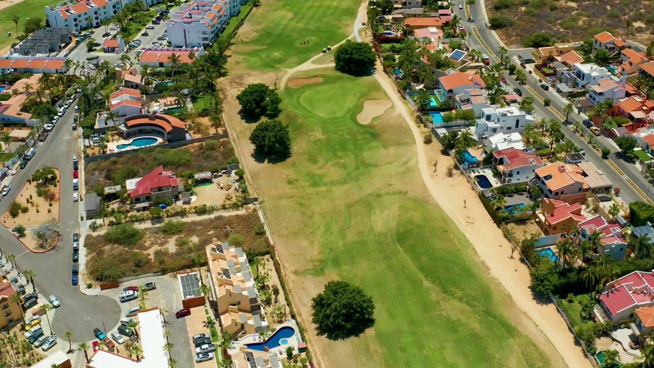 Residential streets and golf course seen from above.