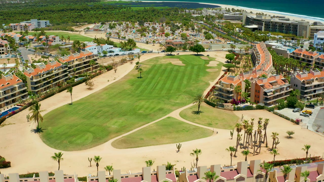 Golf fairway and resort buildings with beach and ocean beyond