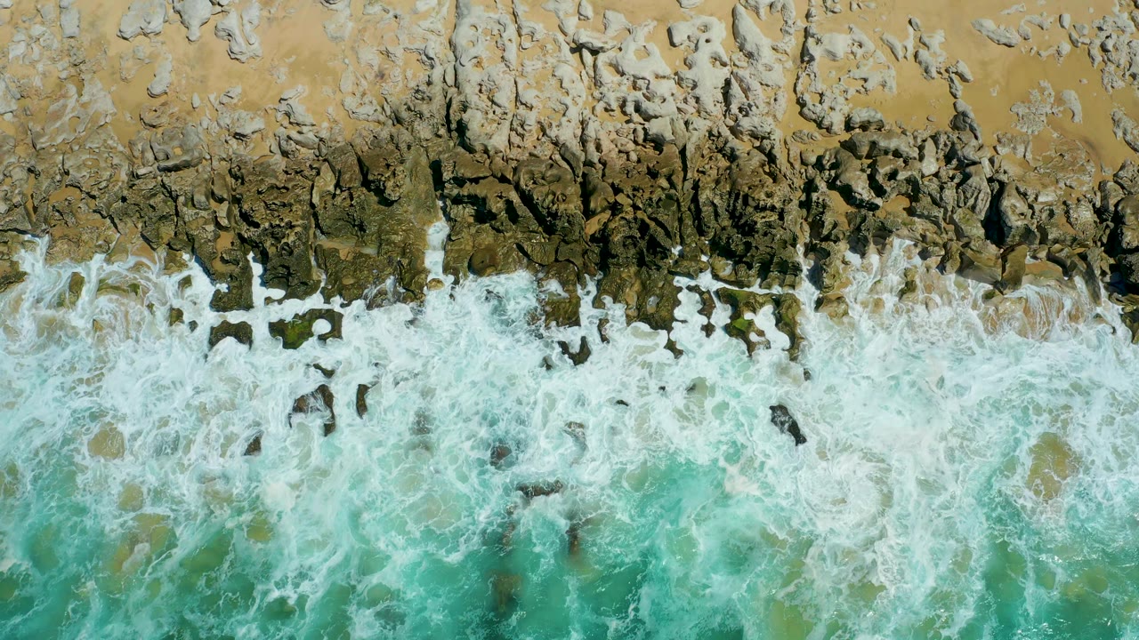 Surf washing through dark rock channels