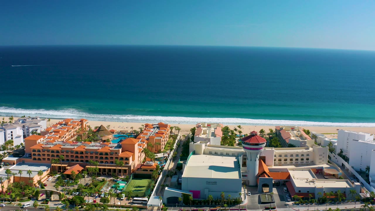 Coastal buildings in front of ocean waves and beach