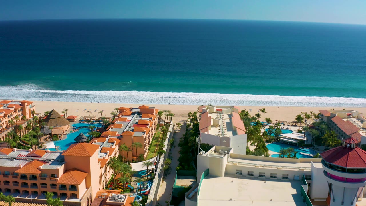 Wider ocean view above resort buildings and sandy beach.