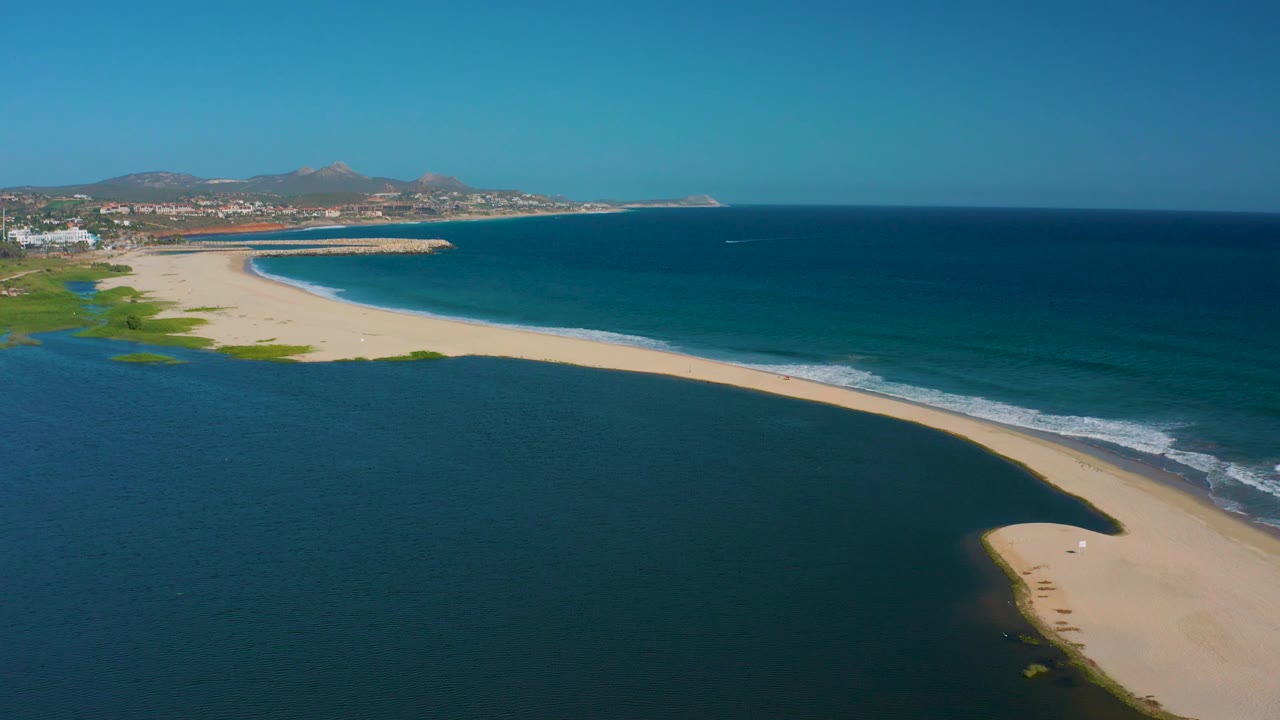 Lagoon and ocean divided by a long sandy beach