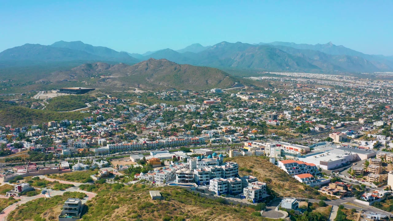 Hillside foreground with city and mountain horizon