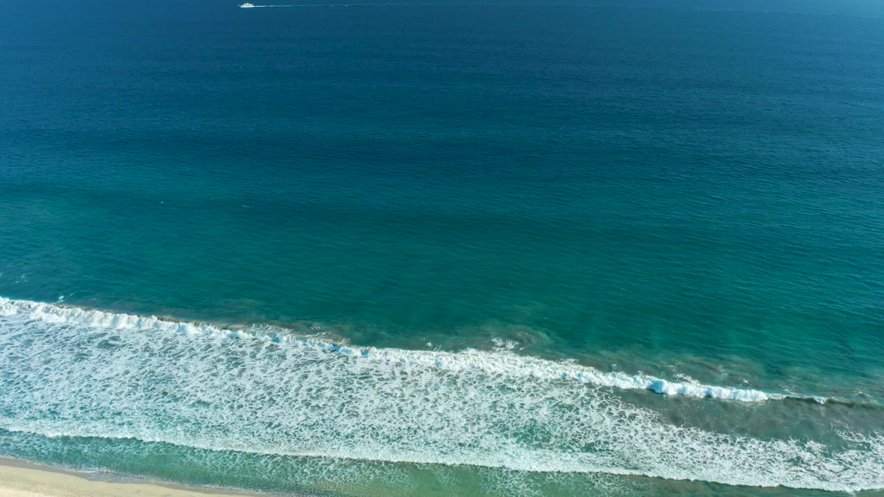 Open ocean with breaking waves along the lower edge