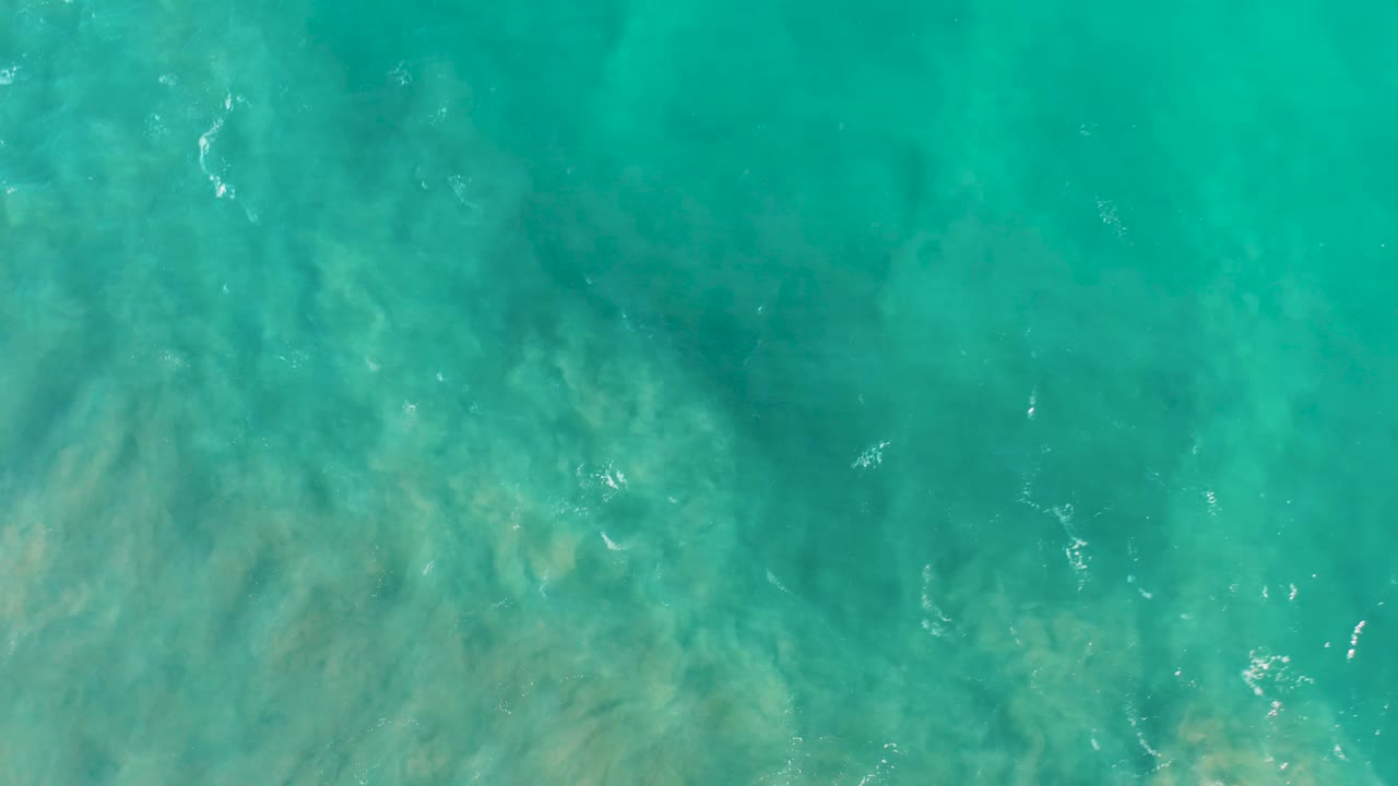 Transparent ocean surface with ripples and seabed