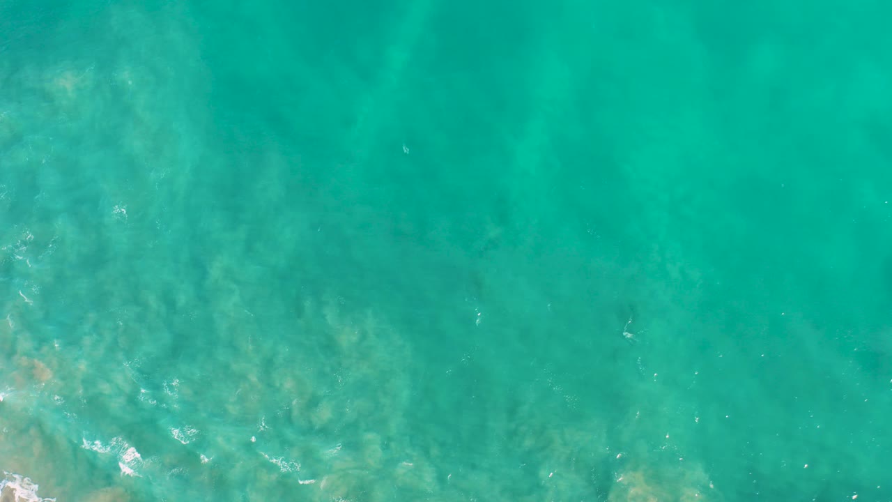 Turquoise ocean water over a visible seabed