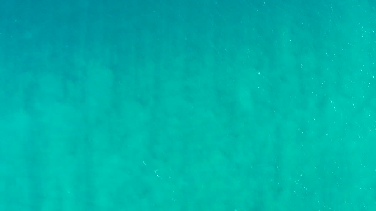 Turquoise underwater view in San Jose Del Cabo, Baja California Sur, with a soft sandy bottom pattern and no visible people.