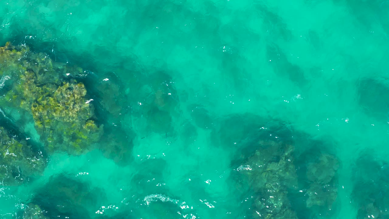 Turbulent shallow water over rocky formations.