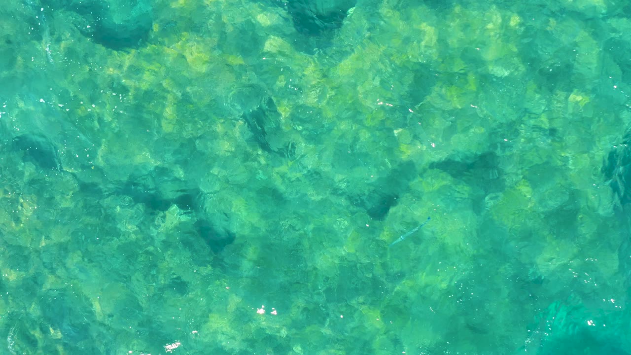 Transparent turquoise ocean with mottled reef bottom