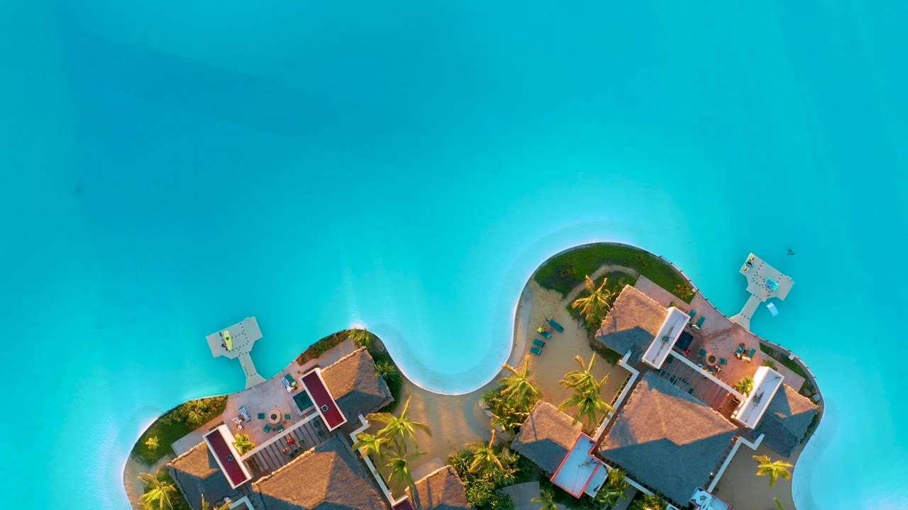 Island homes at frame edge with wide turquoise water