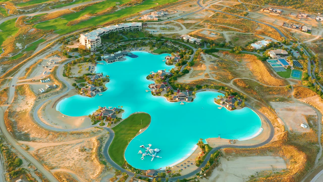 Aerial view of man-made lake with exposed dry land and roads around it.