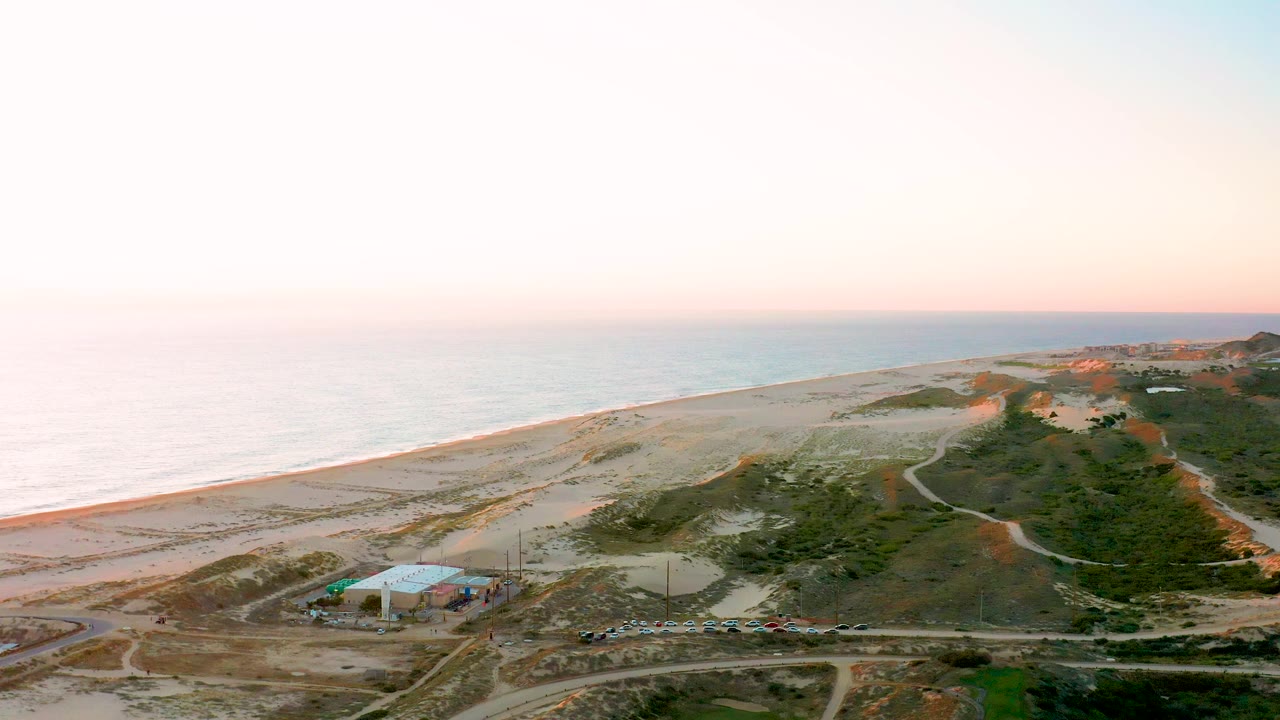 Third frame shows Diamante Cabo San Lucas from above with a curved road near the dunes, surf line along the sand, distant structures on the right, and no visible people.