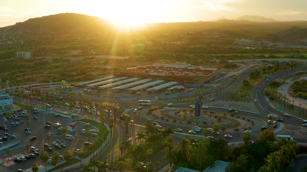 Aerial view of a roundabout with traffic at sunset
