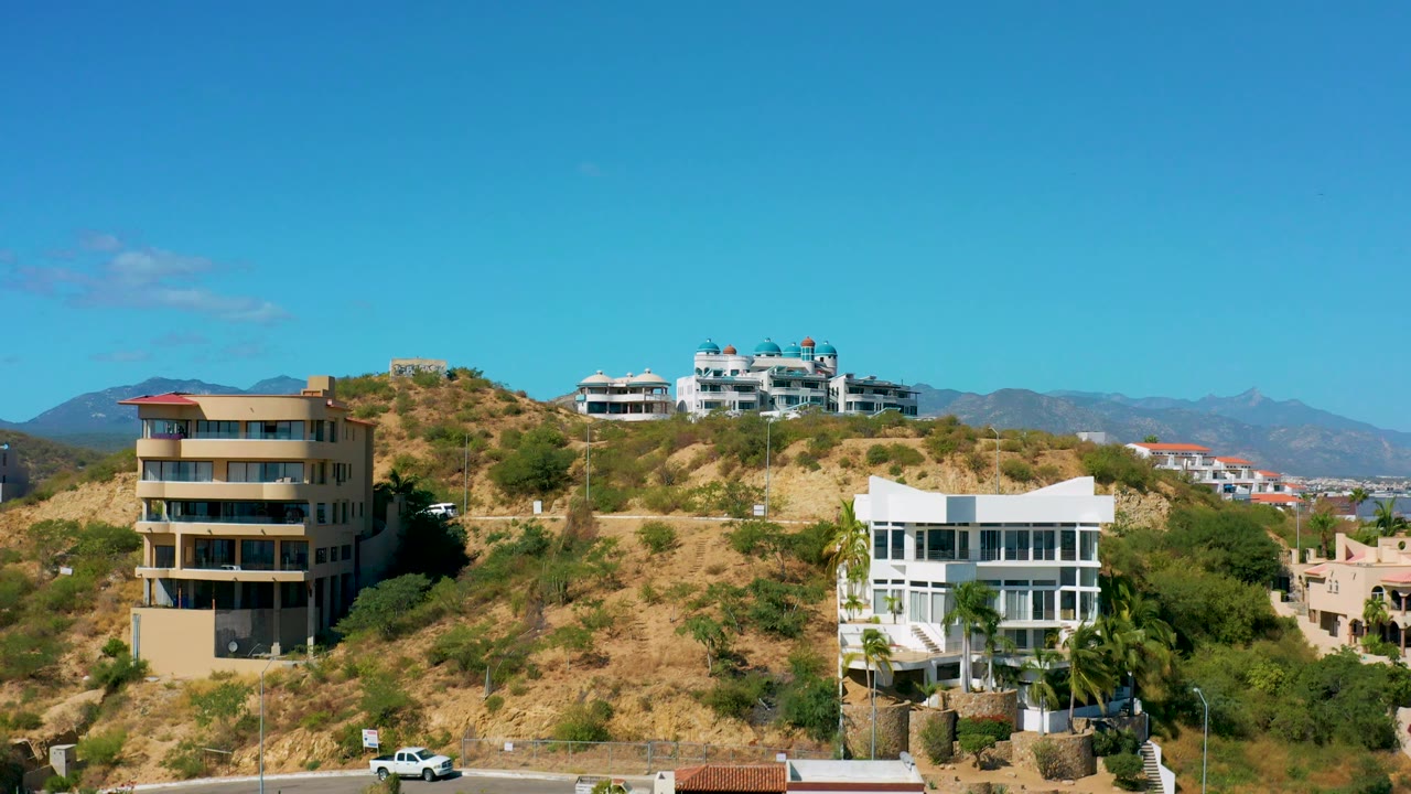 Drone view revealing road below hillside homes