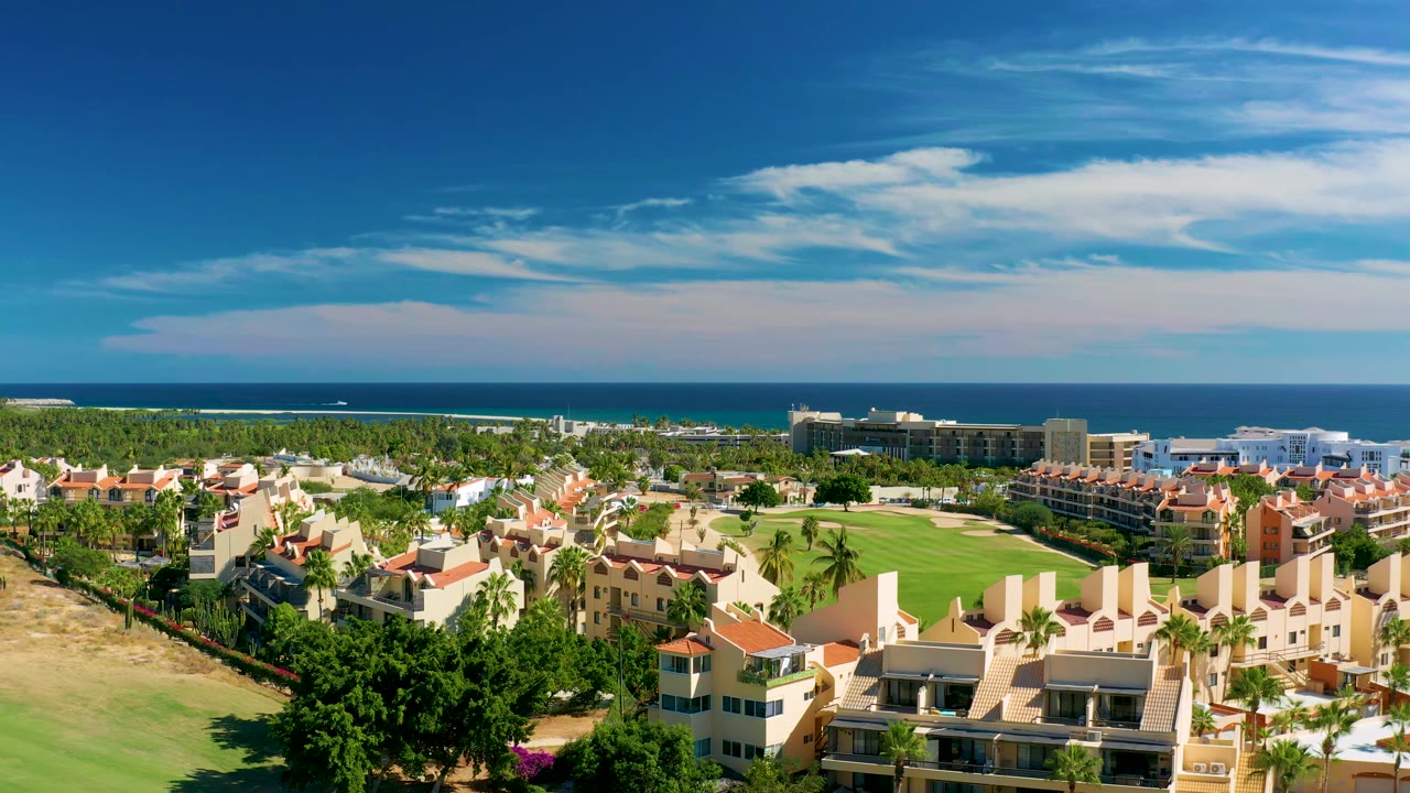Coastal residential development beside a golf course and ocean.