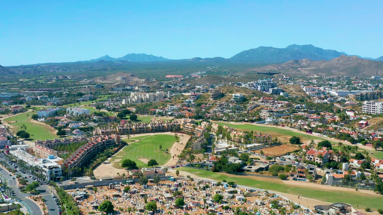 High view across a residential neighborhood and golf-course greens.