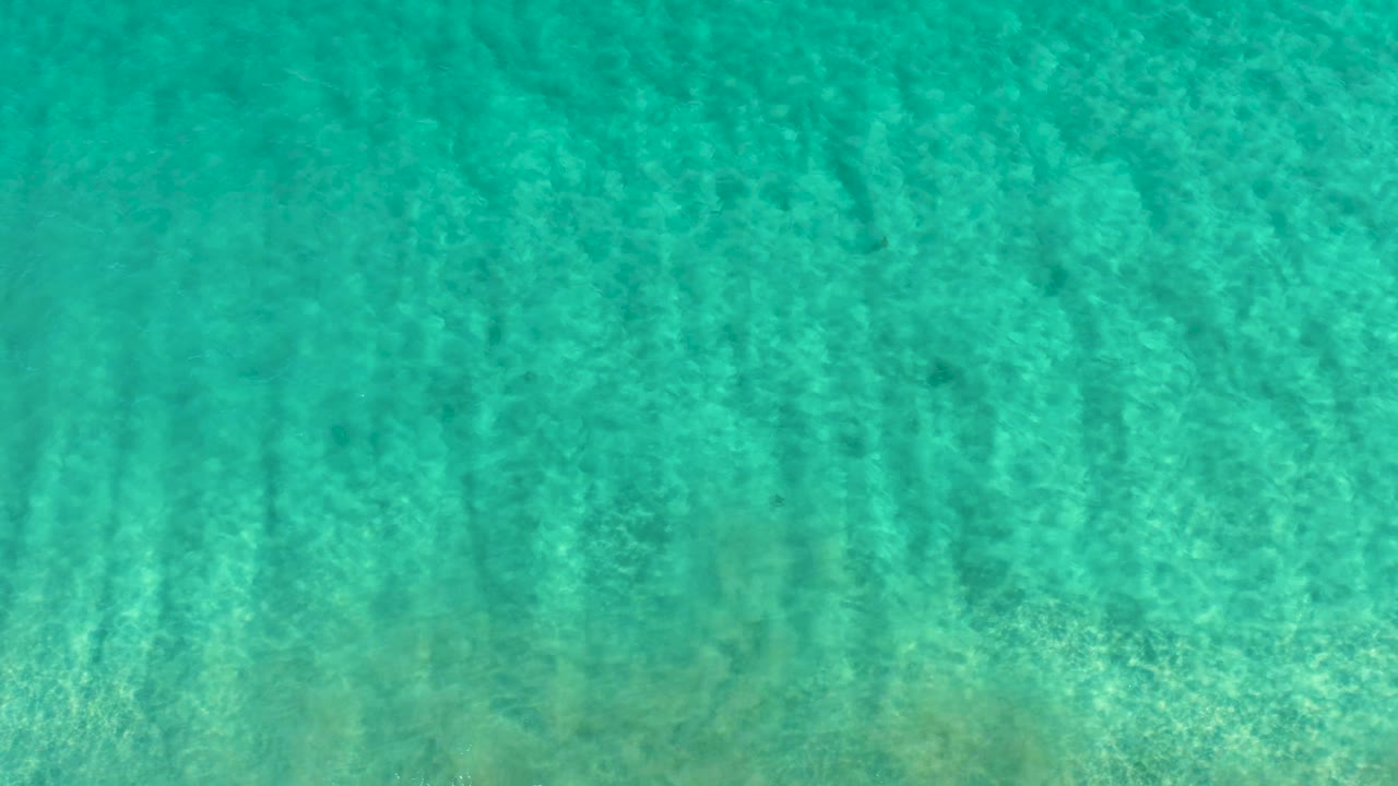 Clear green blue ocean water with rippled surface