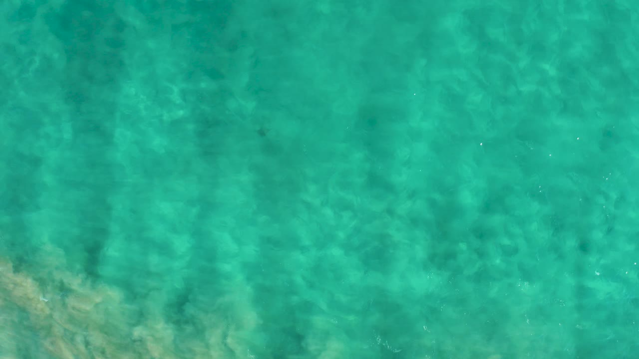 Turquoise water surface with soft wave texture