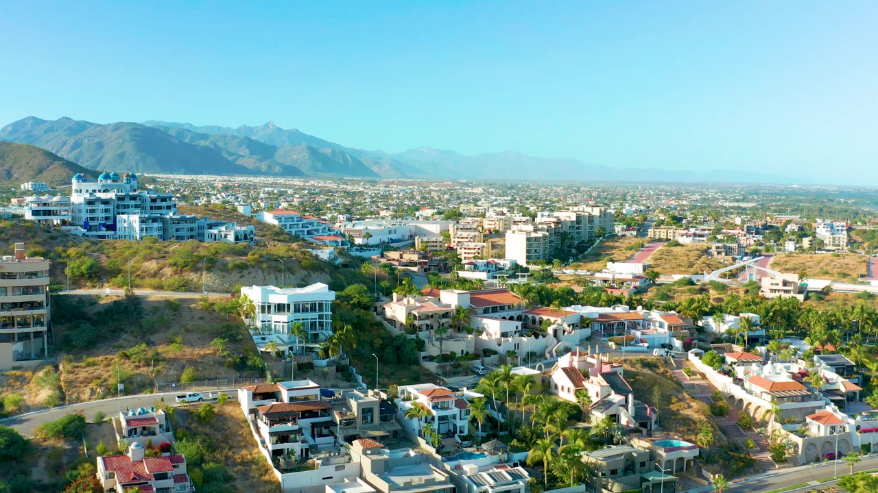 Urban residential area with hillside foreground and mountains