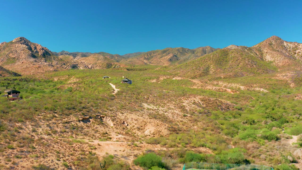 Aerial view of rocky hills with dirt roads and scattered vegetation