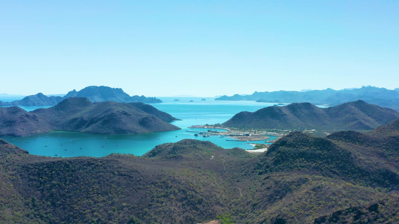 Wide bay aerial with boats, hills, and clear blue sky
