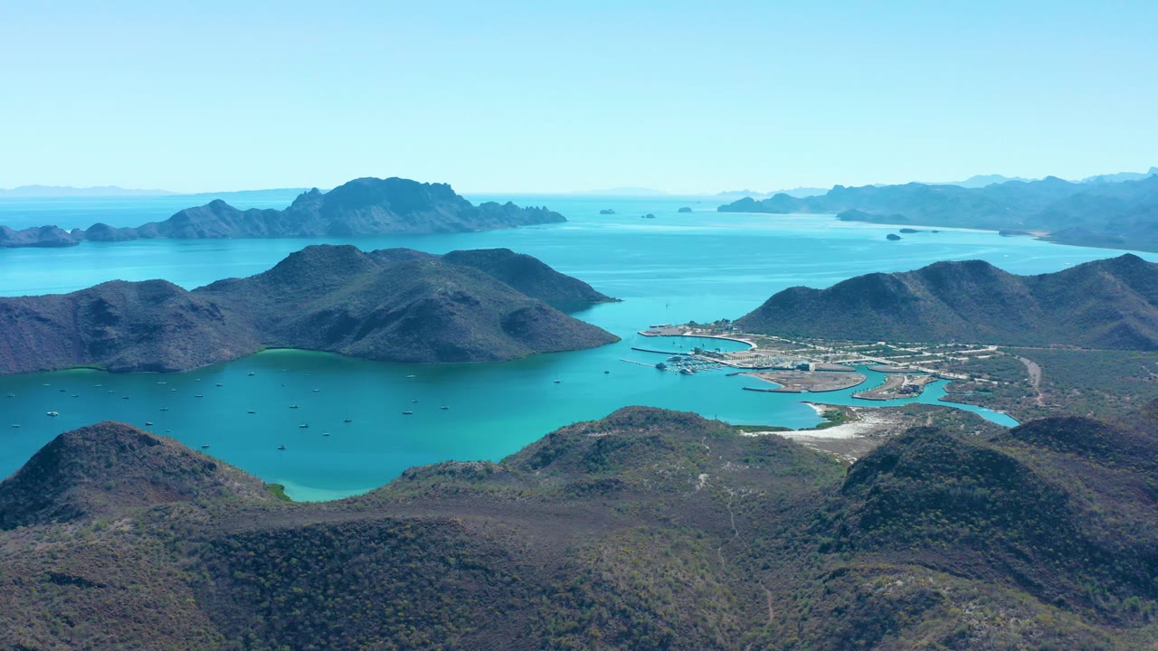 Aerial landscape of bay, boats, harbor, and layered mountain islands