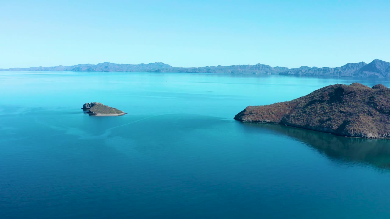 Wide sea view with small island and mountain horizon