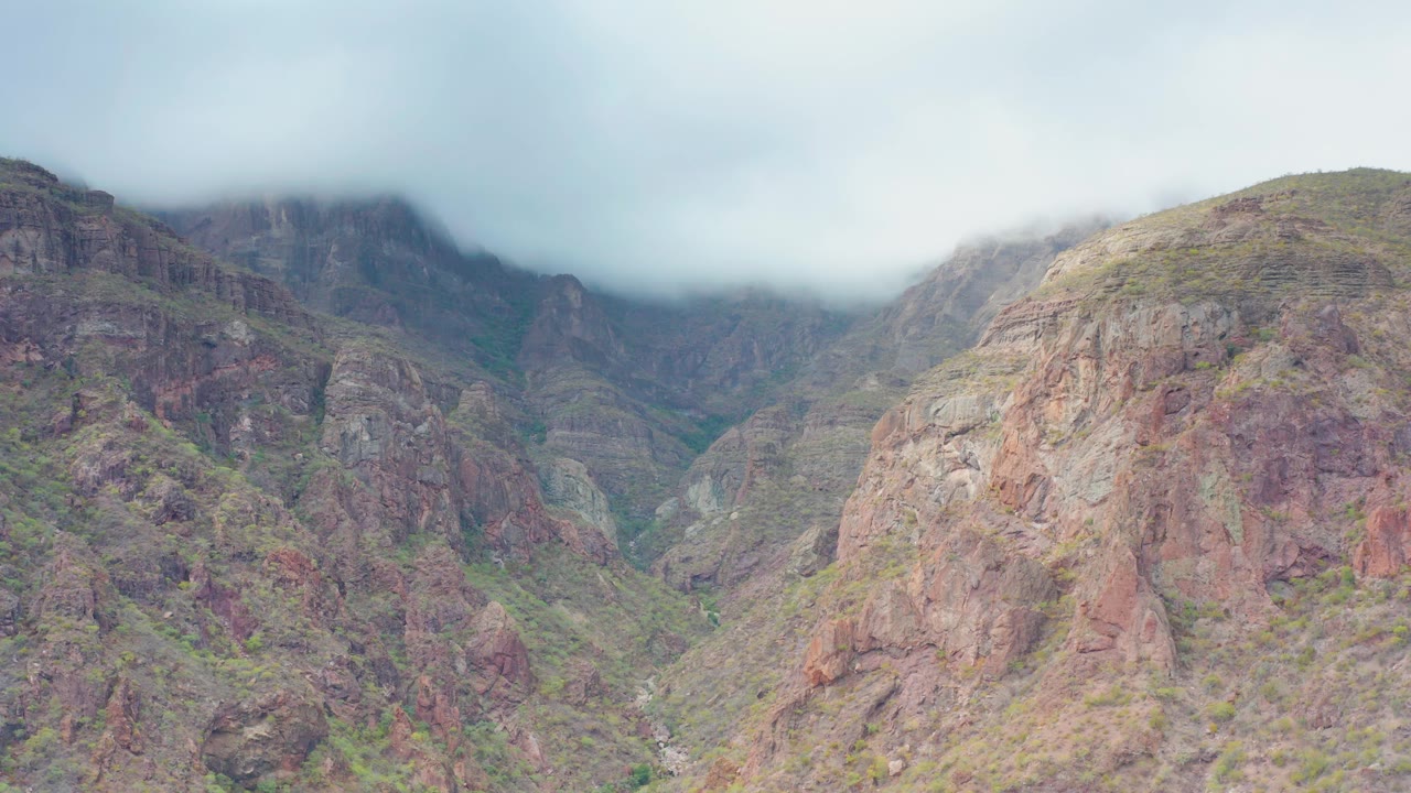 Central rocky slope with clouded ridges