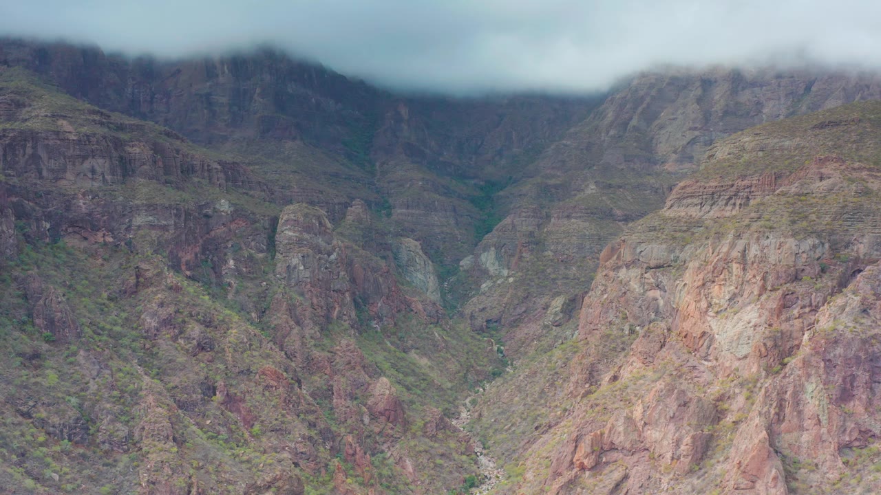 Overcast mountain valley with steep canyon walls