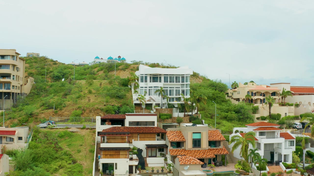 Hillside houses beneath overcast sky