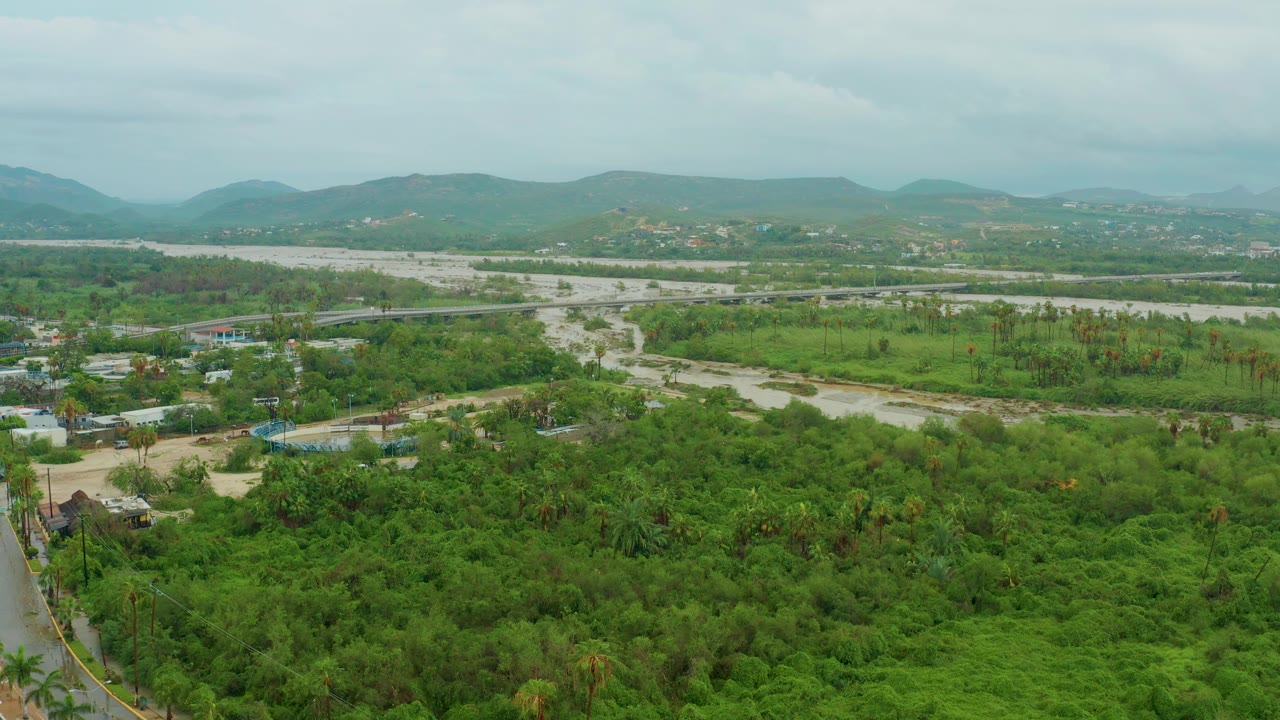 Green river valley with road at lower left and hills on the horizon