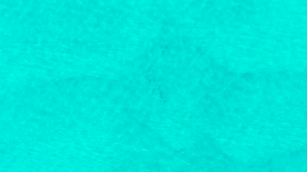 Turquoise shallow ocean water with faint ripples