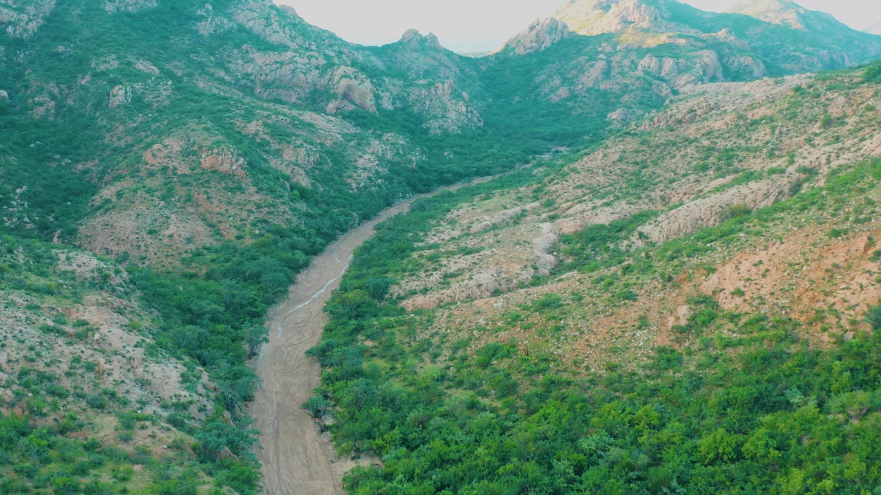 River bend running through rocky green hills
